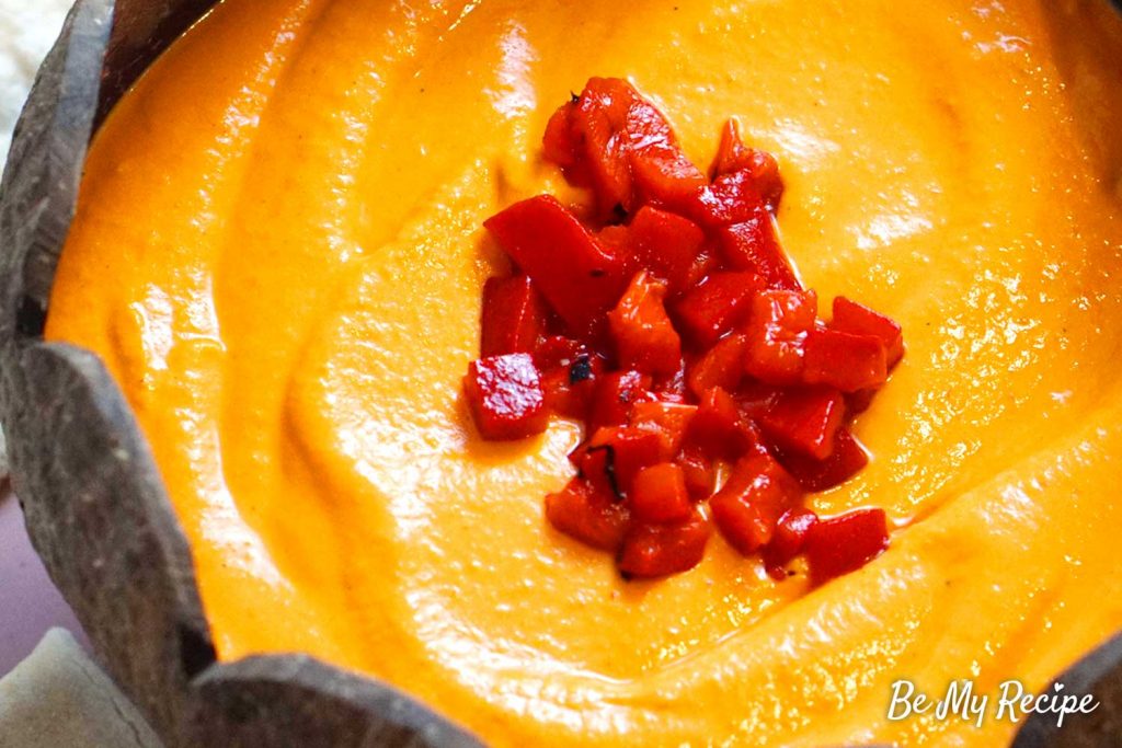 Roasted red pepper hummus with chopped peppers (up-close)