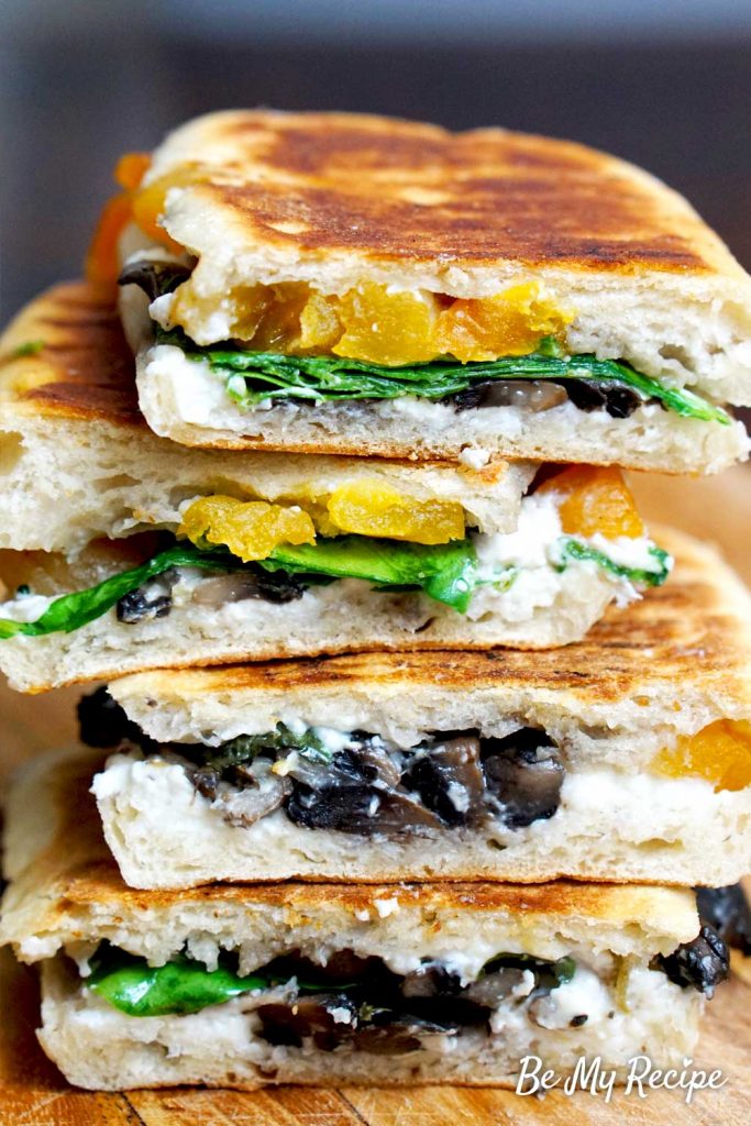 Mushroom and Goat Cheese Panini (stacked on a wooden board, showing the ingredients).