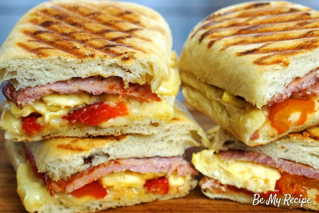 Breakfast panini with bacon, eggs, and roasted pepper.