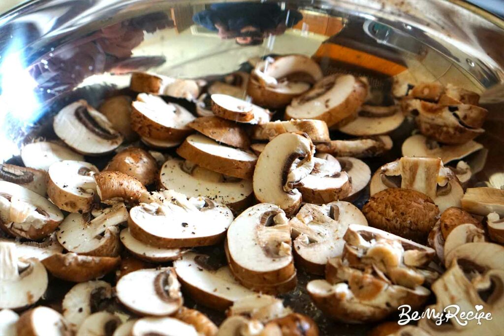 Sauteing the mushrooms in a pan.
