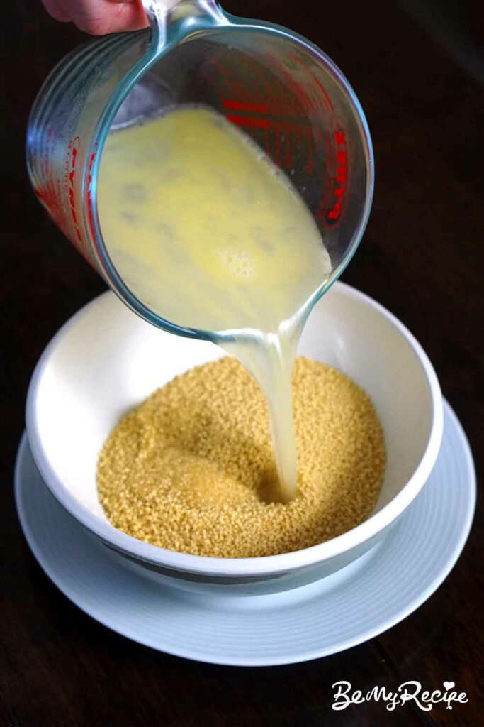 Pouring the water-melted butter mix over the couscous