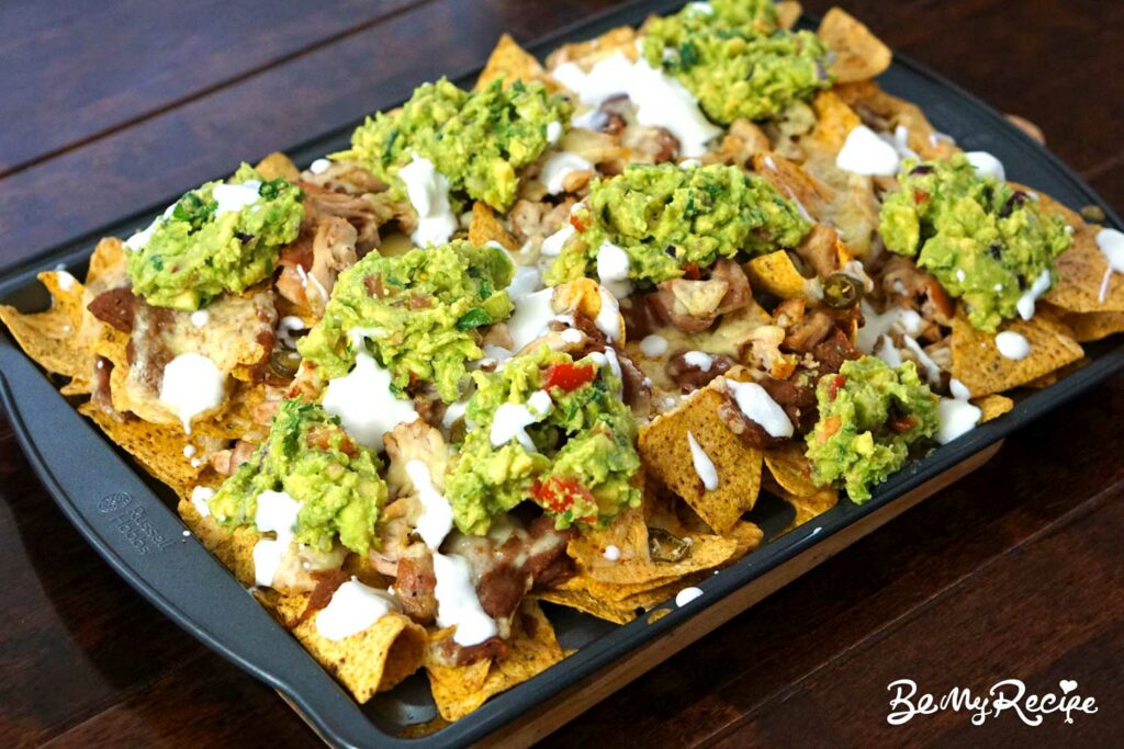 baked nachos with sour cream and guacamole.