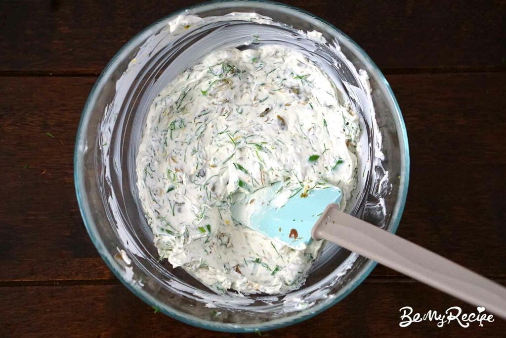 Mixing the cream cheese with the herbs, capers, and lemon