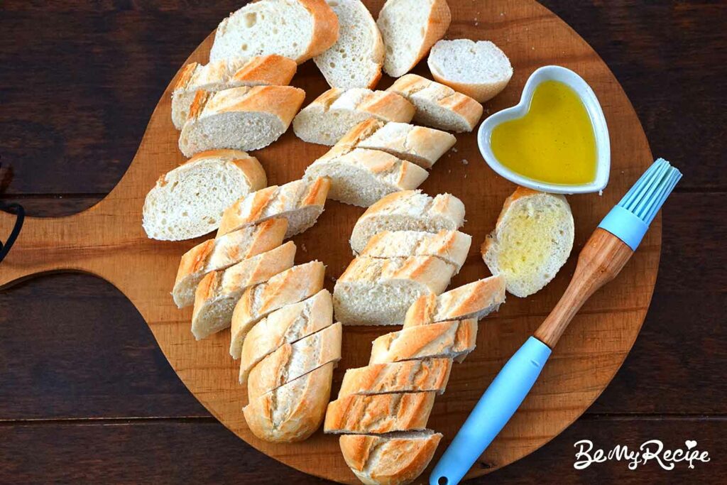 Slicing the baguettes and brushing with olive oil