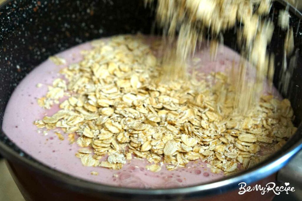 Adding the oats to the strawberry-milk