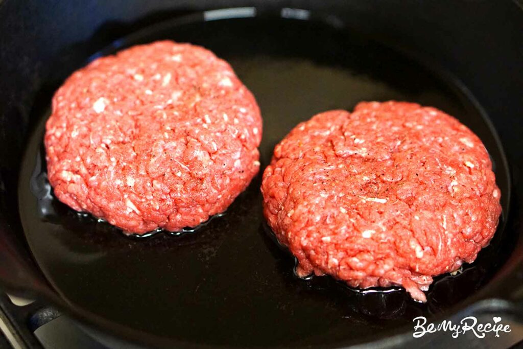 Cooking the stuffed burger patties