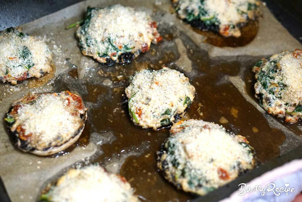 Adding breadcrumbs and parmesan to the stuffed mushrooms