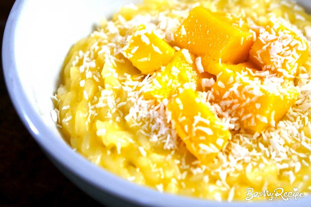 Mango coconut rice pudding with shredded coconut on top.
