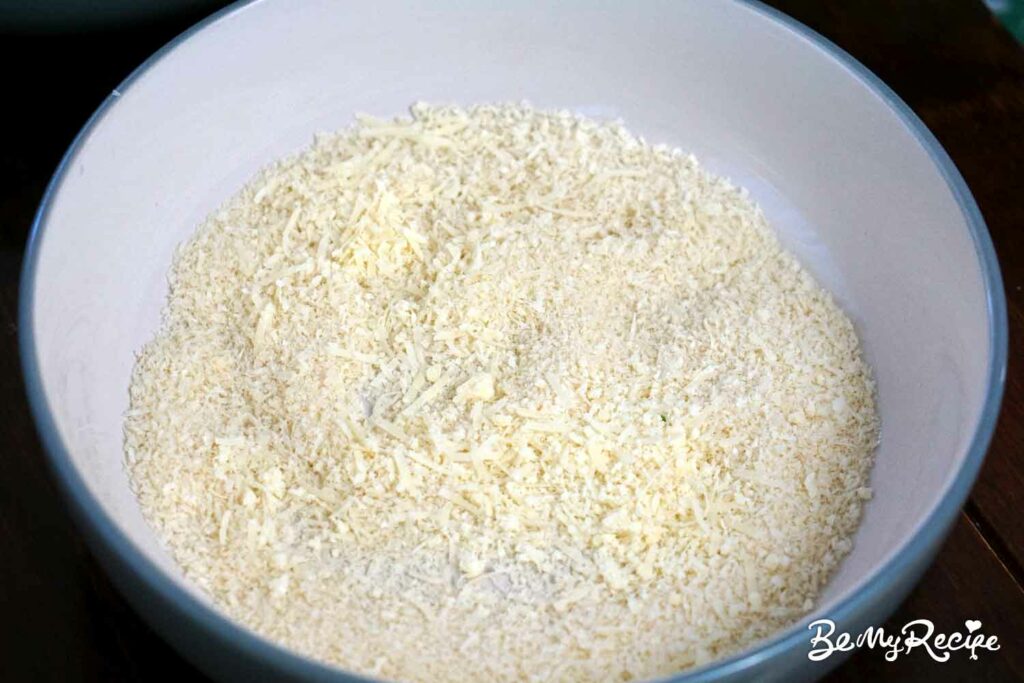 Adding parmesan to the breadcrumbs