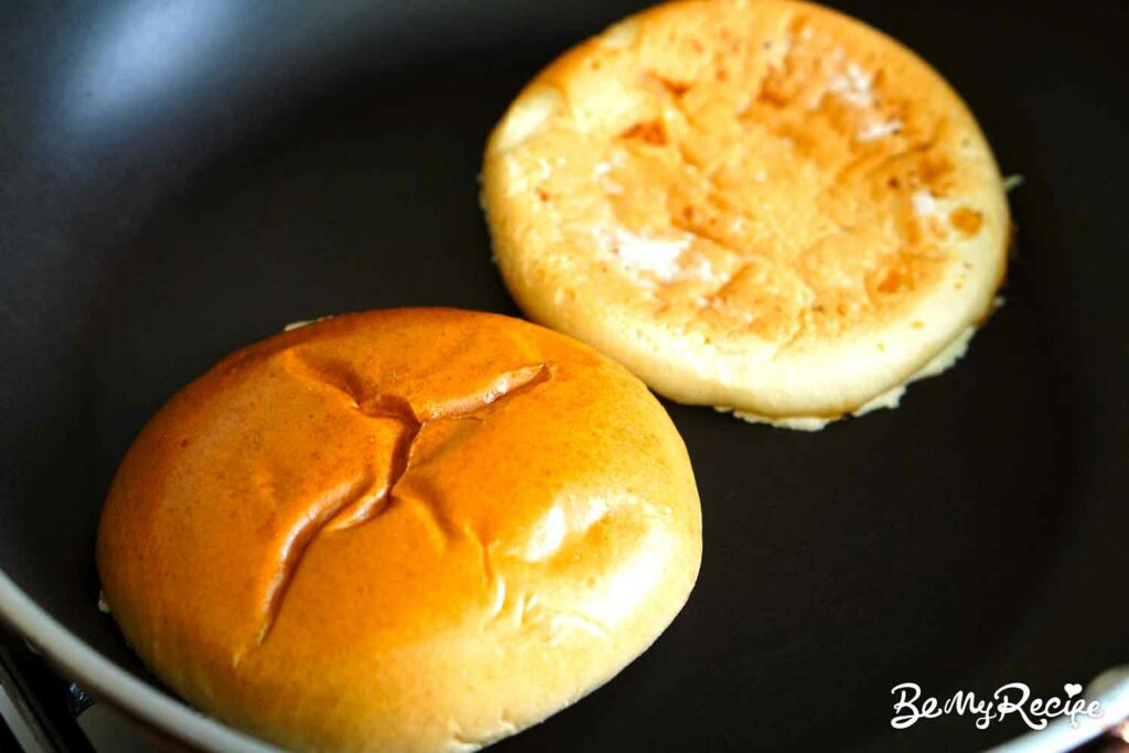 Toasting the buns in a pan.