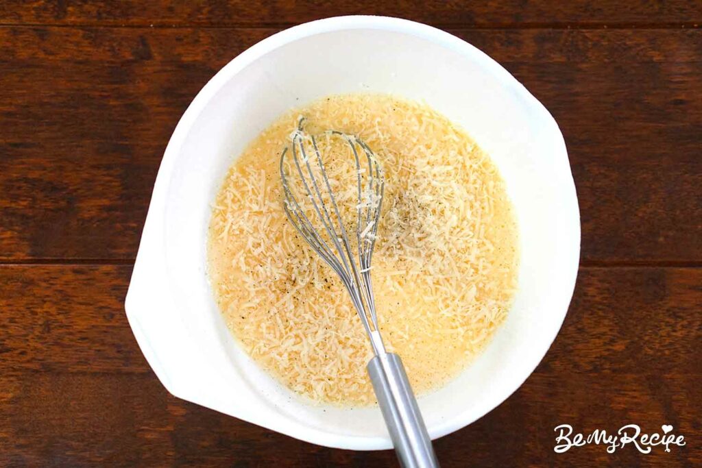Adding parmesan to the eggs
