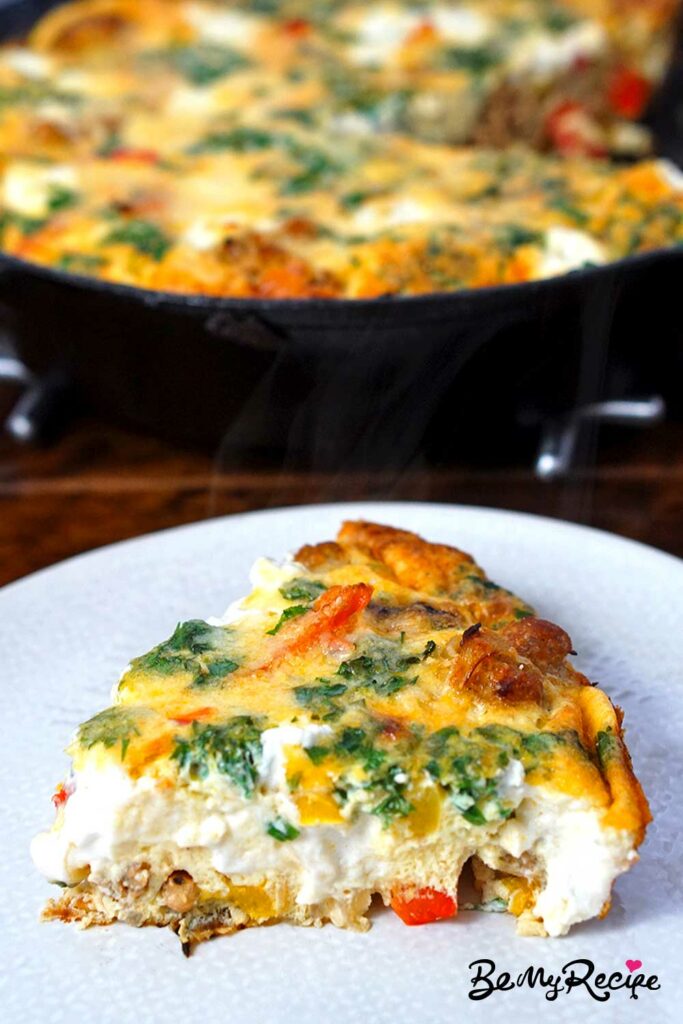 A slice of frittata on a plate.