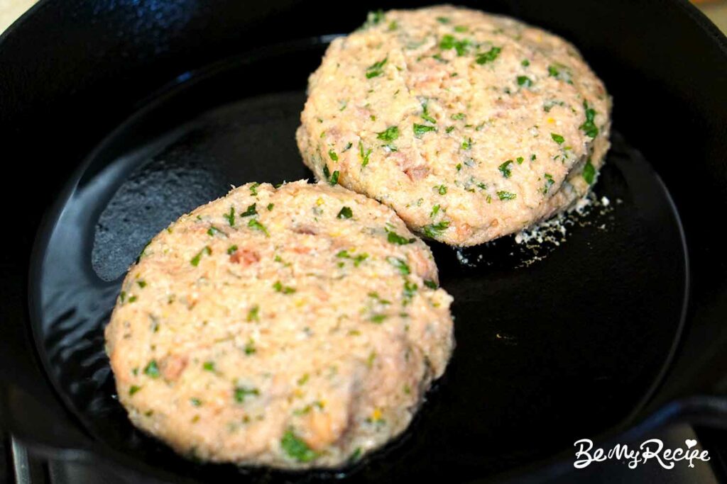 Cooking the salmon burger patties.