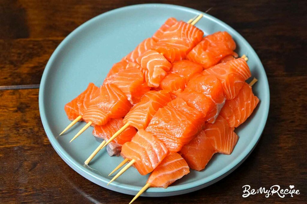 Adding the salmon to skewers