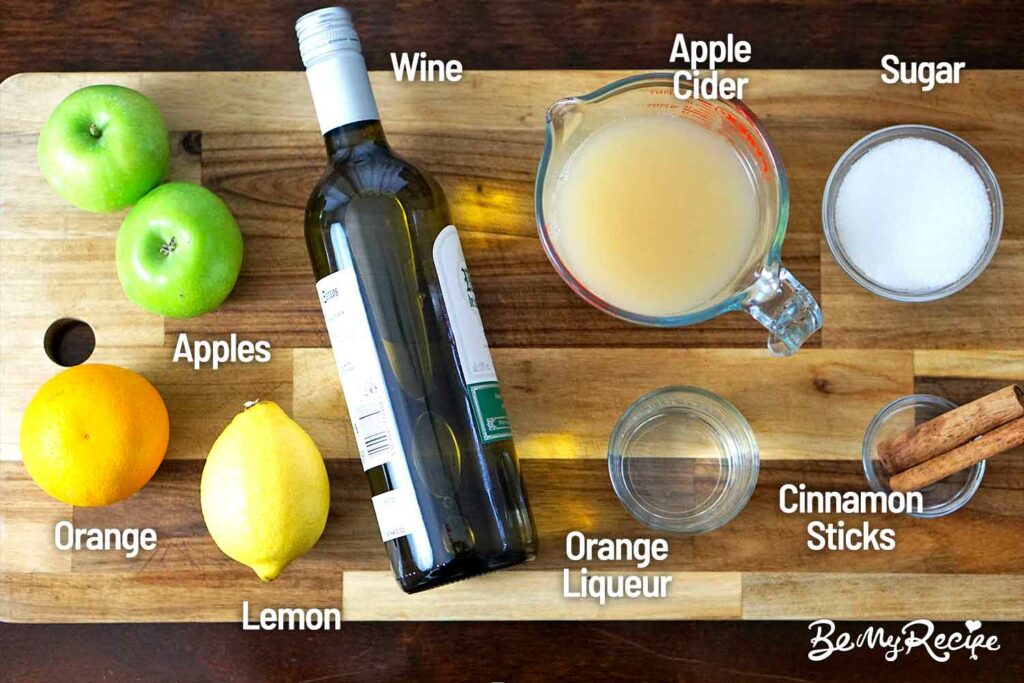 Apple Cider Sangria ingredients on a wooden board