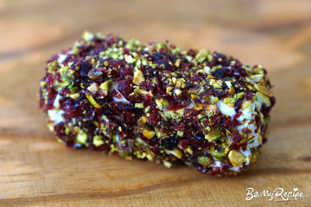 Goat cheese log rolled in pistachios and dried cranberries with honey.