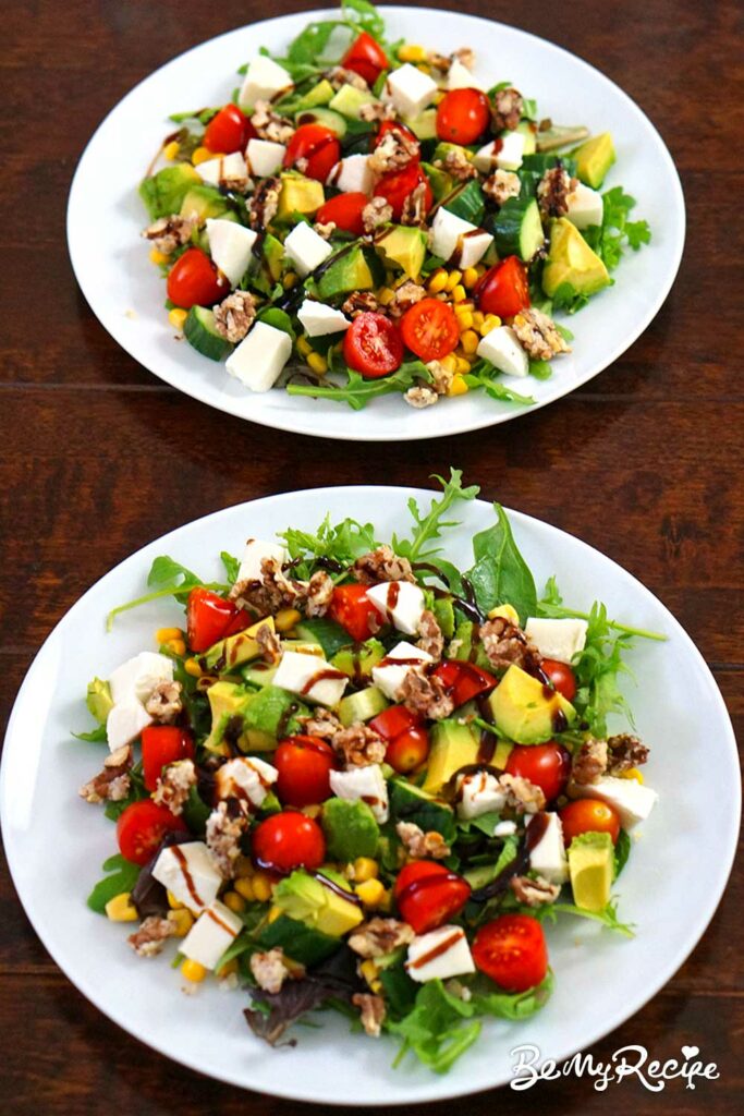 Salad with corn, tomatoes, avocado, and candied nuts