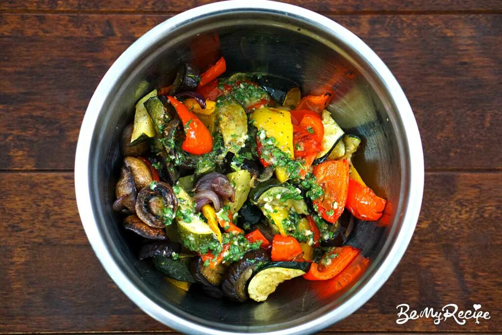Tossing the roasted veggies with the vinaigrette