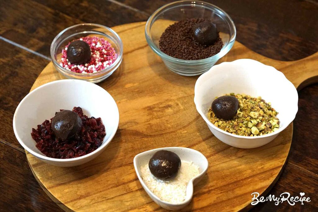 Rolling the chocolate truffles through the various toppings/coatings.