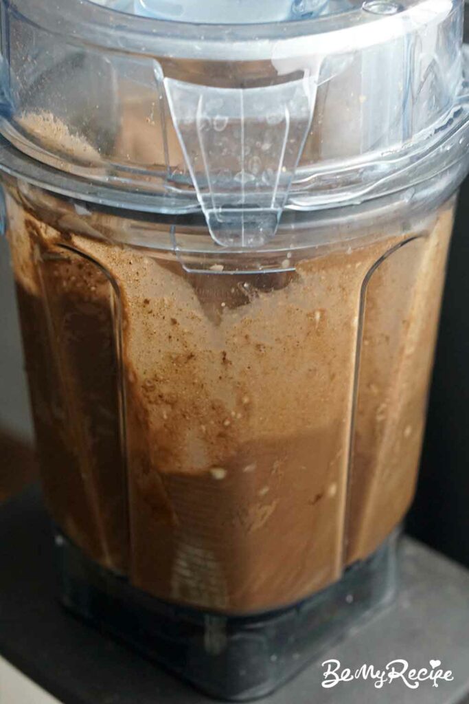 blending banana and hazelnut milk with water and cocoa powder