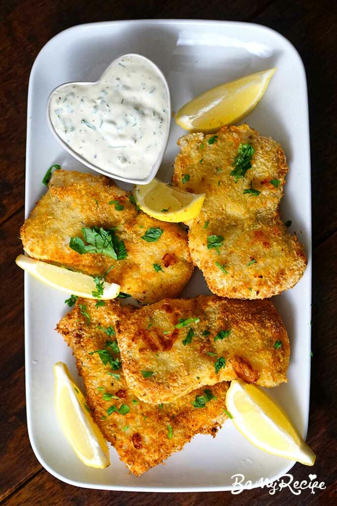 Air Fryer Fish Fillets with lemon wedges, fresh parsley, and remoulade sauce