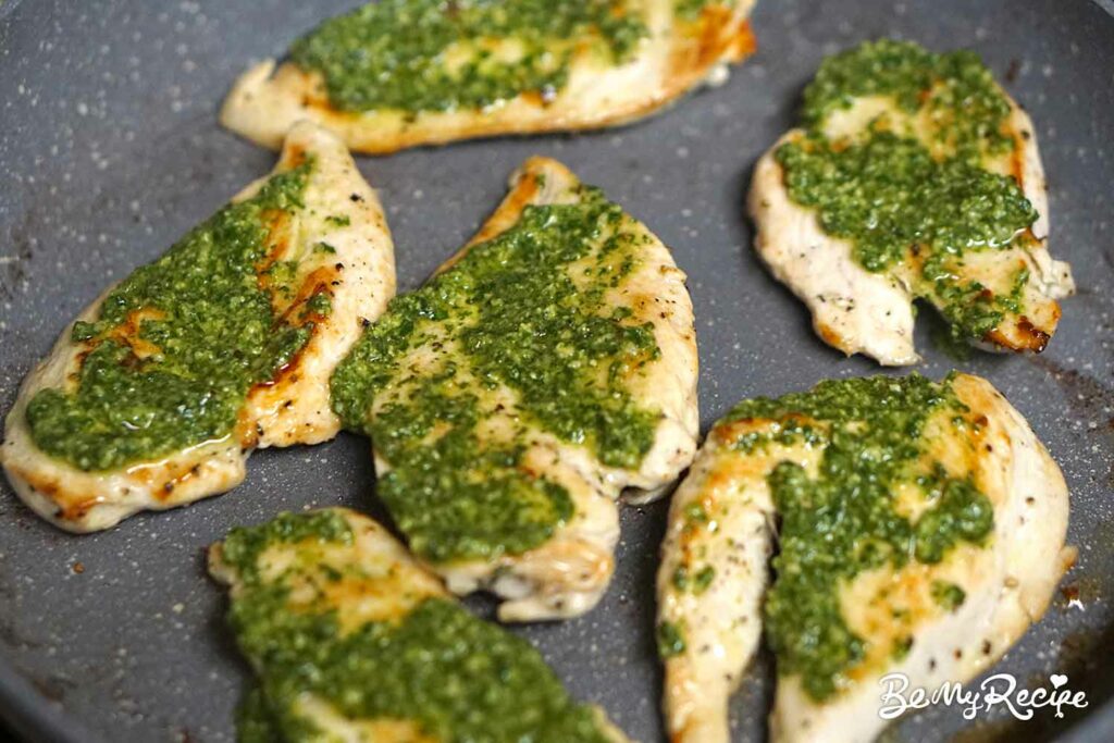 Grilled/pan-fried chicken with fresh basil pesto on top.