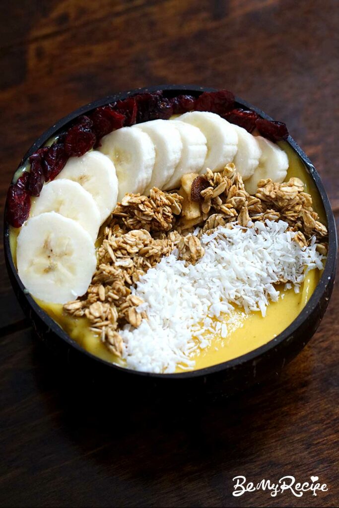 mango banana smoothie bowl with toppings