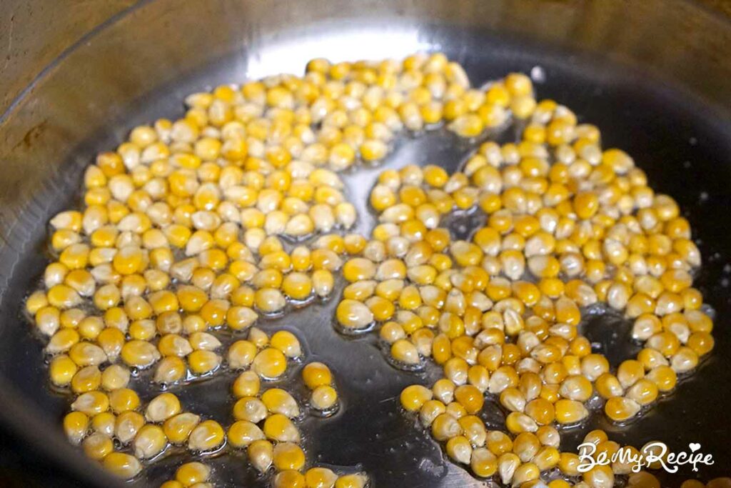 Popcorn kernels in oil in a pot