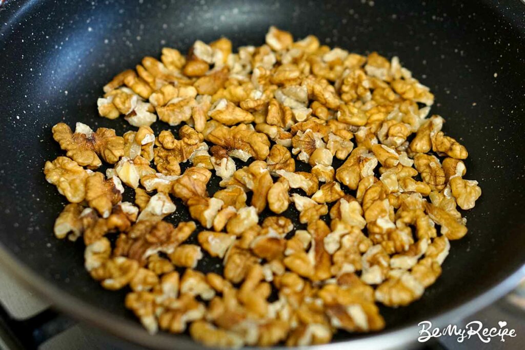 Toasting the walnuts in a small pan