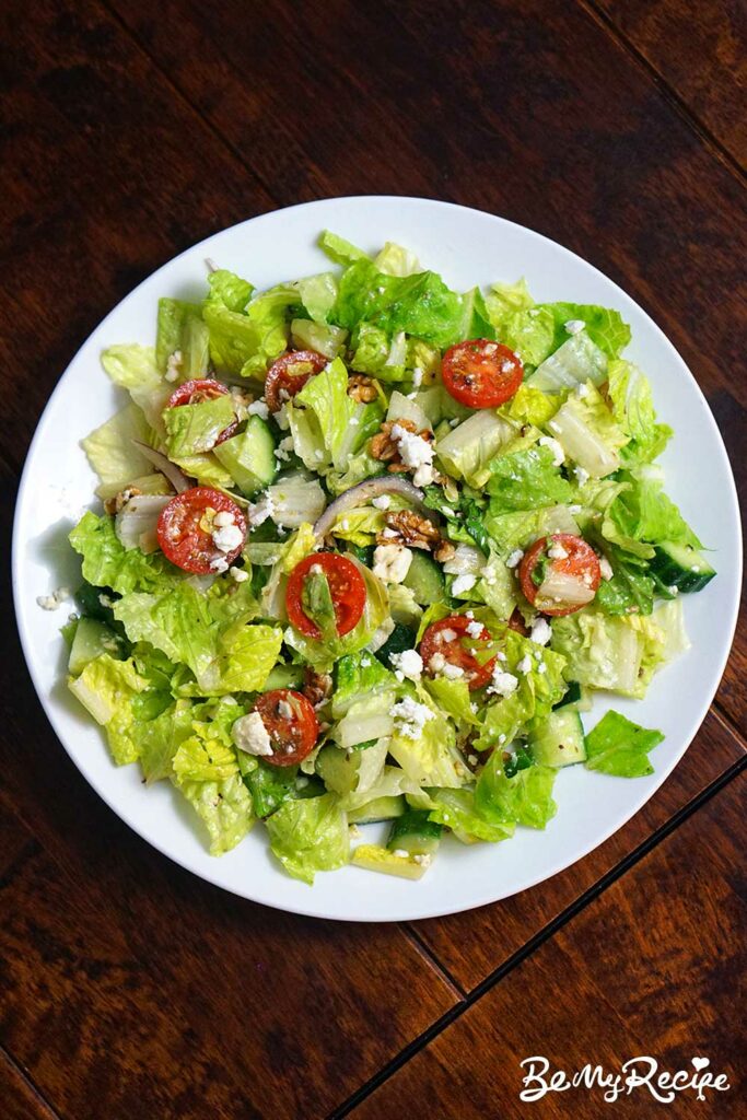 One dinner serving of the romaine salad with feta, walnuts, cucumber, and tomatoes