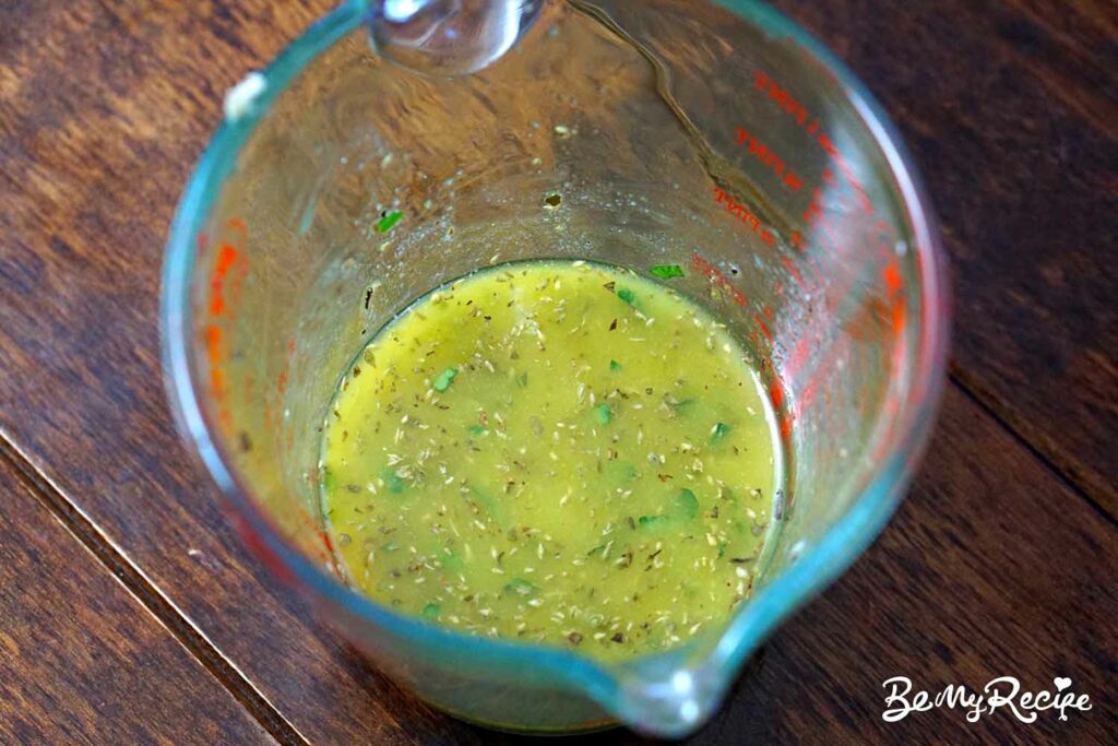 Making the salad dressing by whisking it