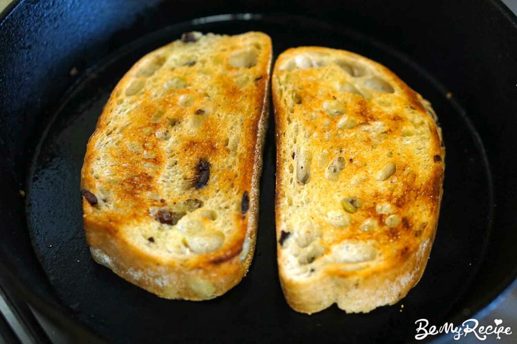 Toasting the bread in a cast iron pan