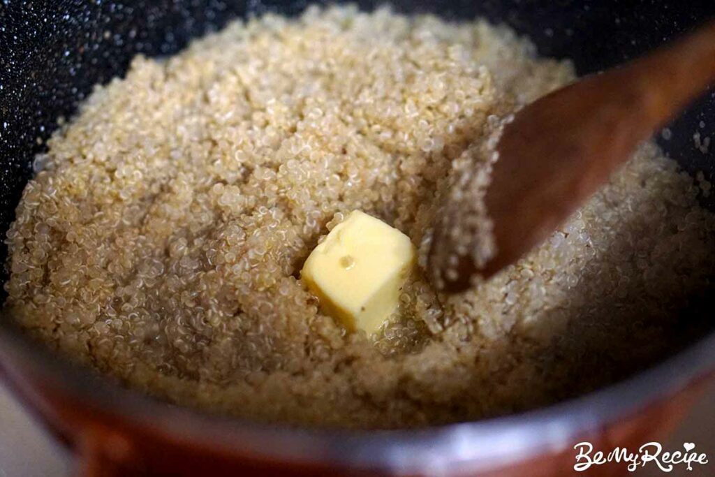 Adding butter to the quinoa