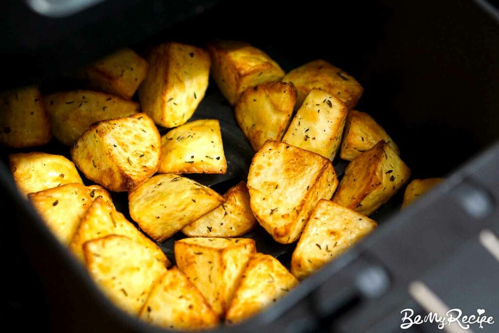 Cooked potato bites in the air fryer basket
