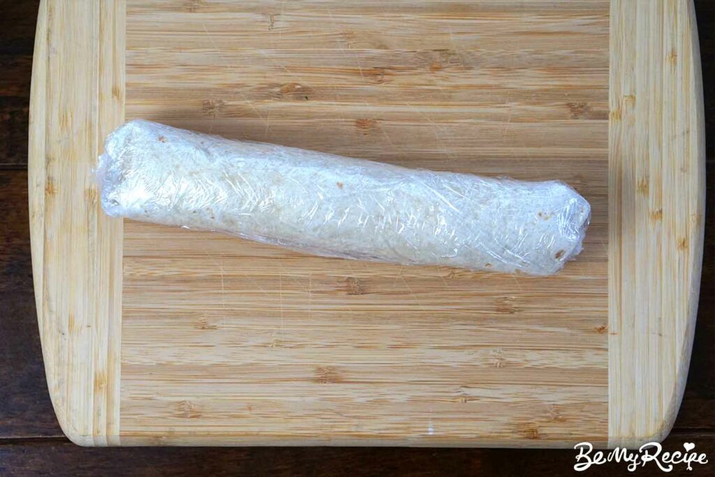 Rolled tortilla in saran wrap/cling film